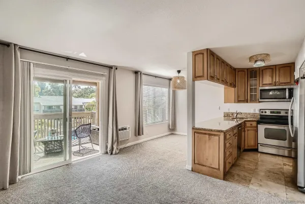 a kitchen with stainless steel appliances granite countertop a stove and a refrigerator