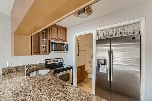 a kitchen with a refrigerator and a sink