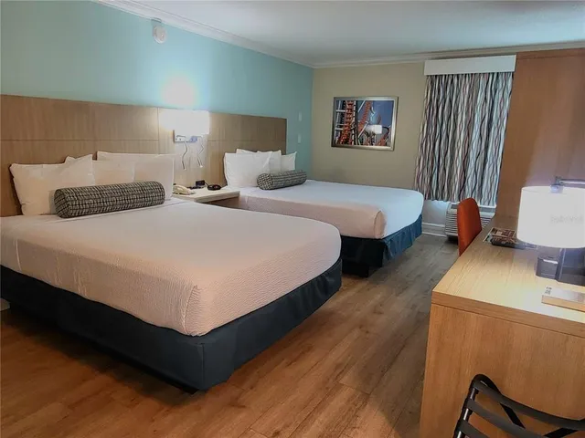 a bedroom with bed and a night stand