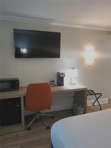 a room with a chair and a flat screen tv