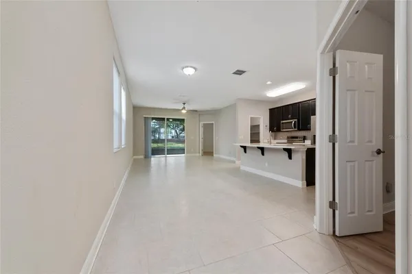 a view of a hallway with wooden floor and a cabinet