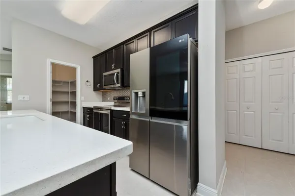 a kitchen with a refrigerator and a sink