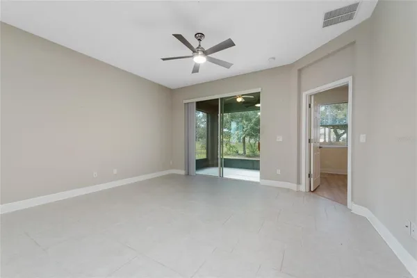 an empty room with closet and windows