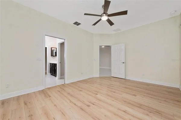 a view of empty room with wooden floor