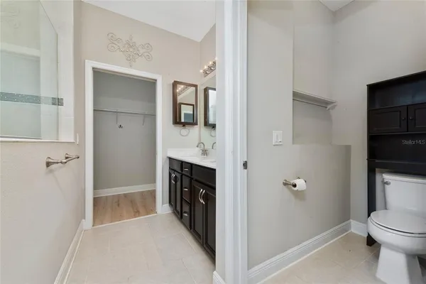 a spacious bathroom with a granite countertop sink a toilet and shower