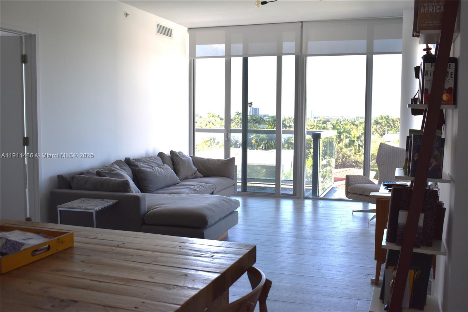 9940 West Bay Harbor Drive, Unit 6DN Bay Harbor Islands, FL 33154 - Photo 12 of 46 a living room with furniture and floor to ceiling window