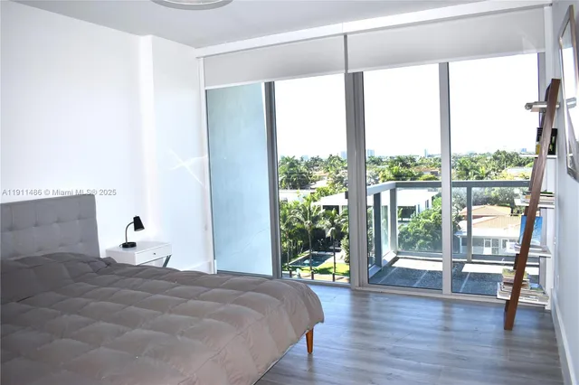 a bedroom with a large bed and a large window