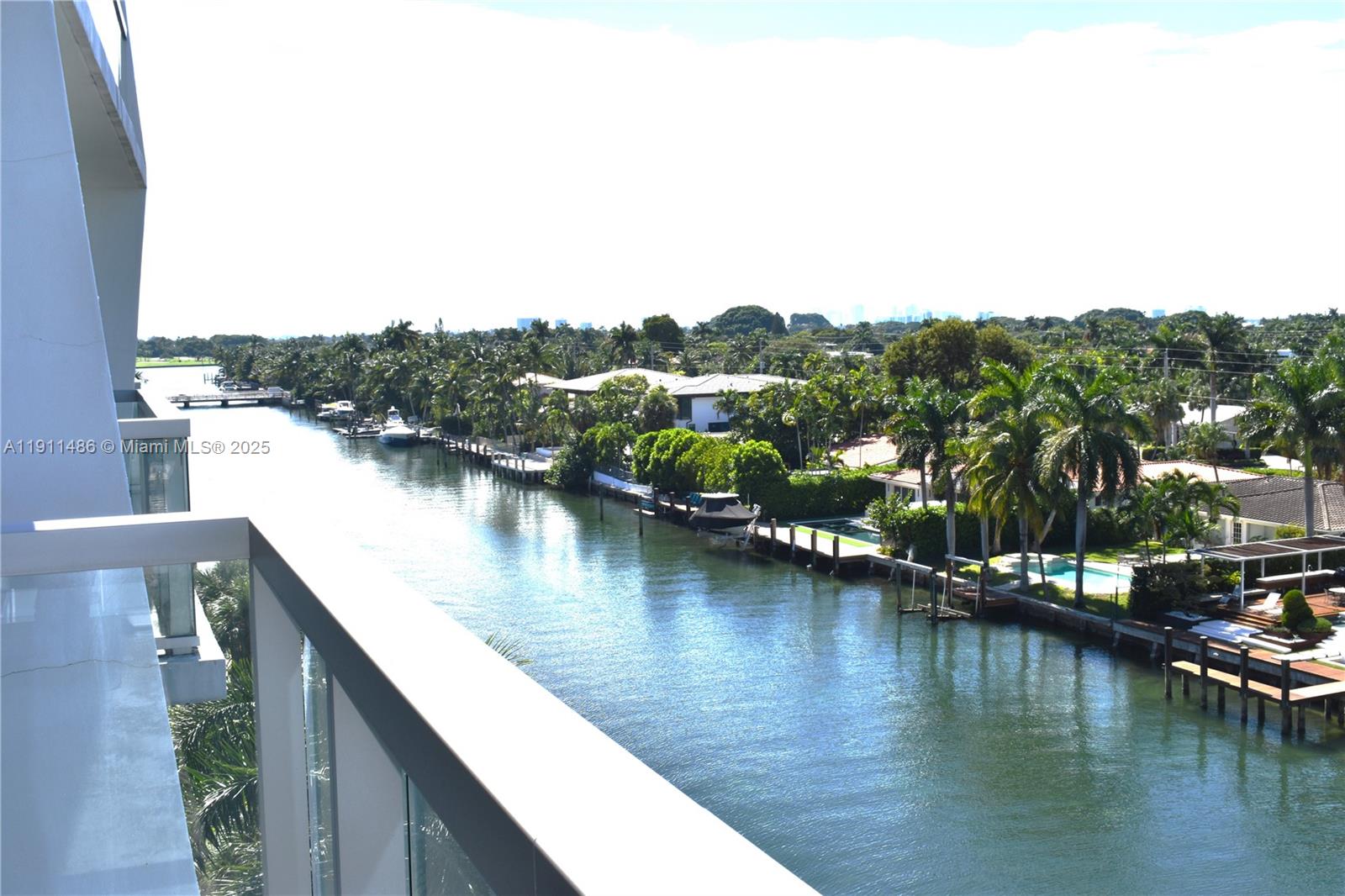 9940 West Bay Harbor Drive, Unit 6DN Bay Harbor Islands, FL 33154 - Photo 18 of 46 a view of a lake with boats and trees in the background