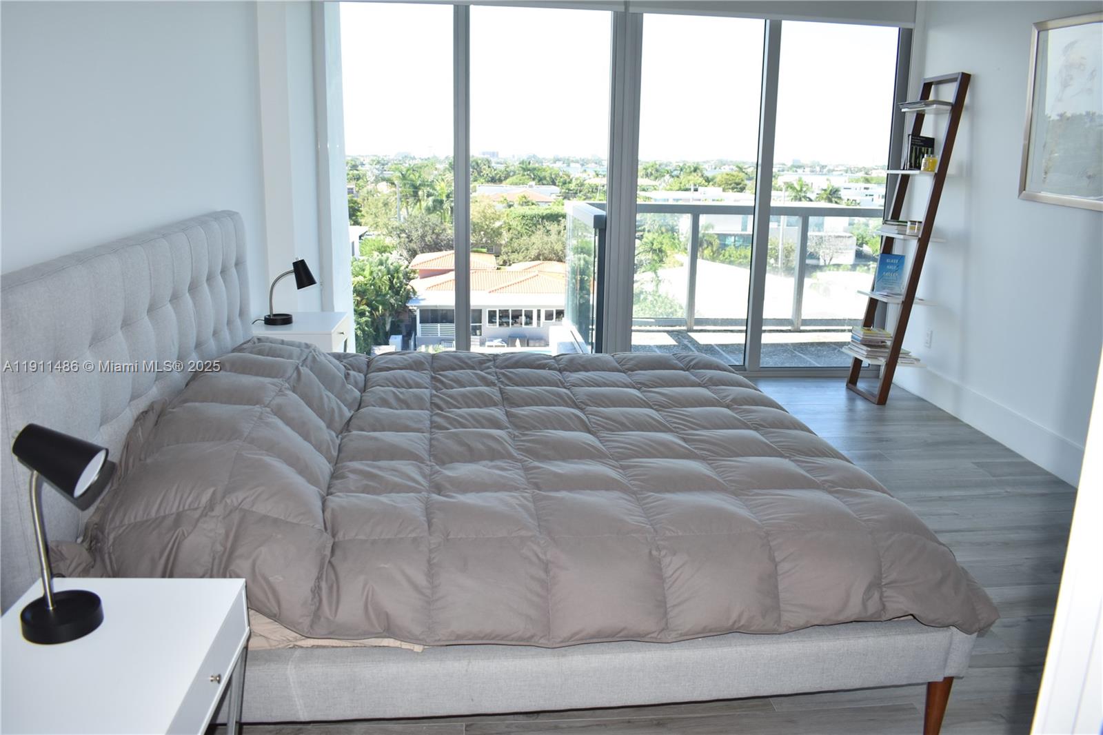 9940 West Bay Harbor Drive, Unit 6DN Bay Harbor Islands, FL 33154 - Photo 22 of 46 a bedroom with a bed and a large window