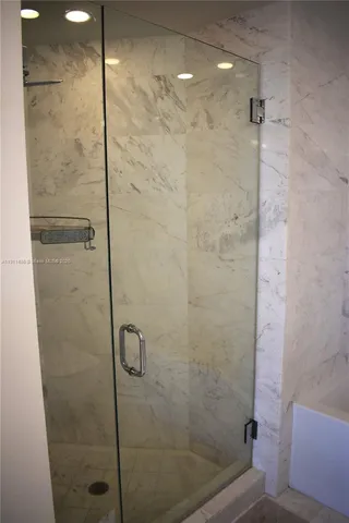 a en suite bathroom with a sink a large mirror and a bathtub