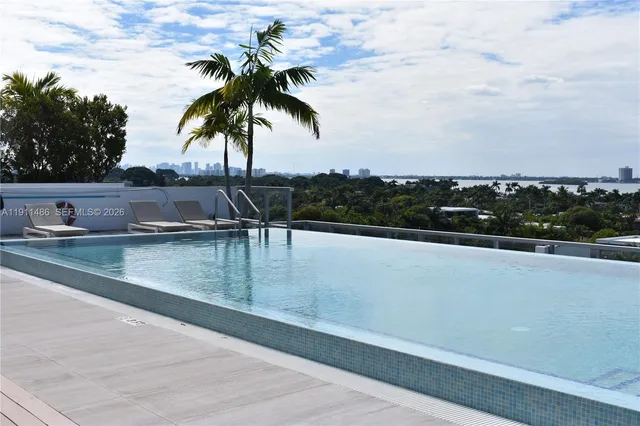 a view of a balcony with wooden floor and fence