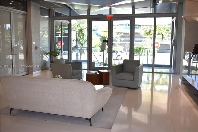 a living room with furniture and large windows