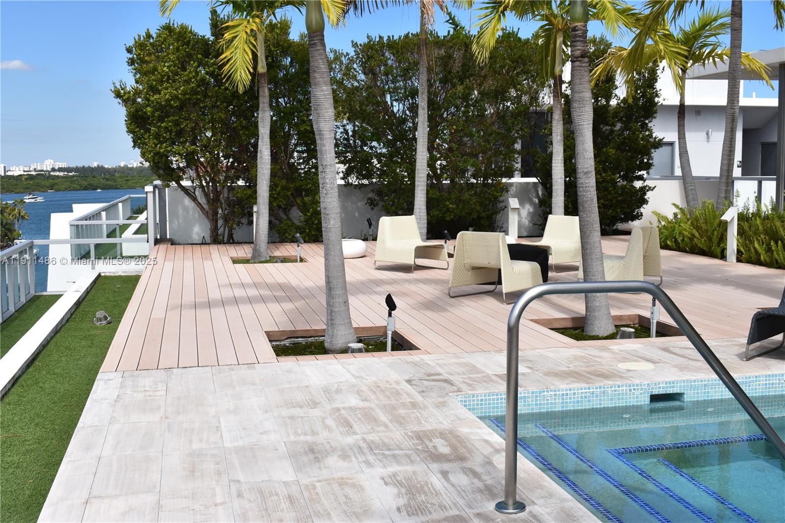 9940 West Bay Harbor Drive, Unit 6DN Bay Harbor Islands, FL 33154 - Photo 43 of 46 swimming pool view with a seating space and a garden