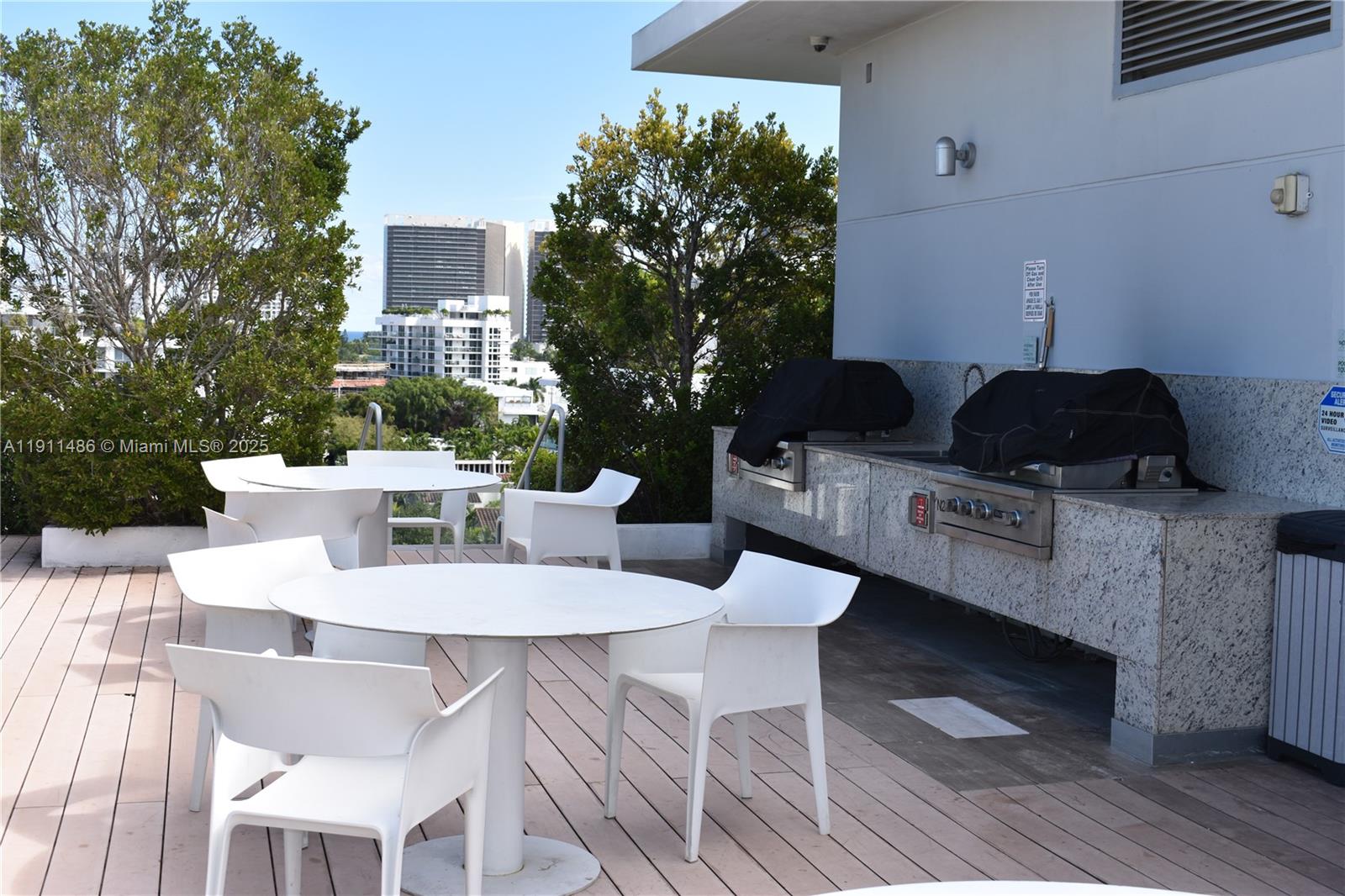 9940 West Bay Harbor Drive, Unit 6DN Bay Harbor Islands, FL 33154 - Photo 44 of 46 a outdoor dining space with furniture and wooden floor