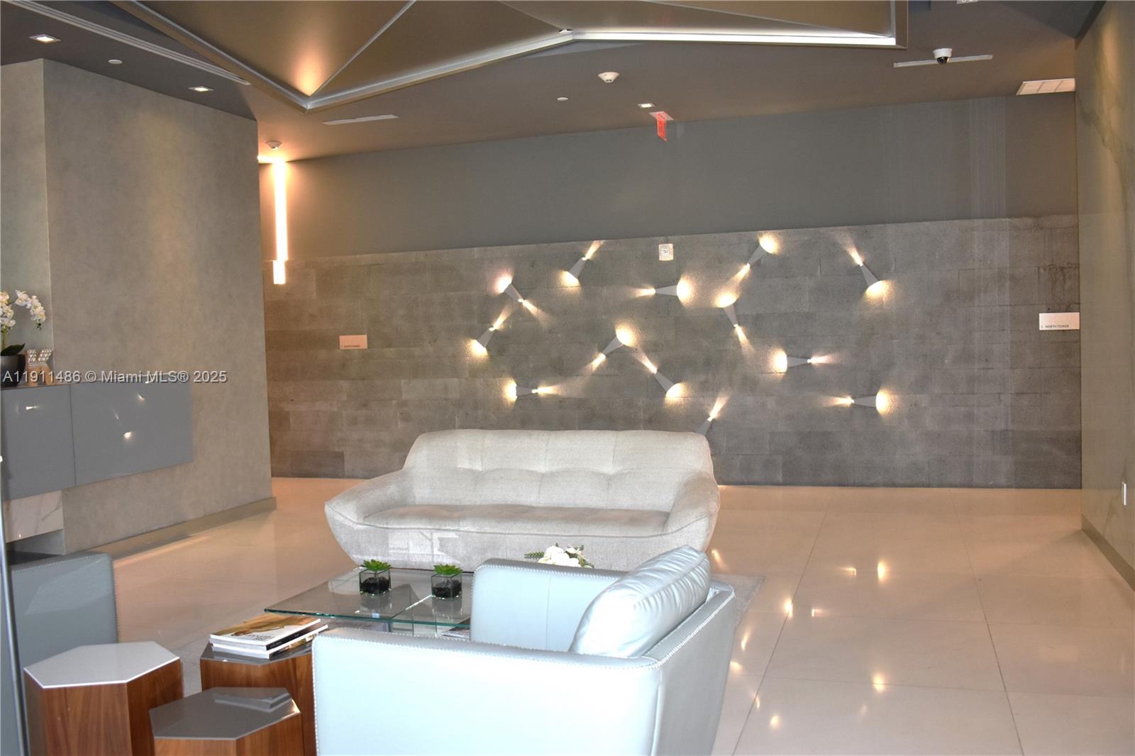 9940 West Bay Harbor Drive, Unit 6DN Bay Harbor Islands, FL 33154 - Photo 5 of 46 a view of a lobby with chair and tables