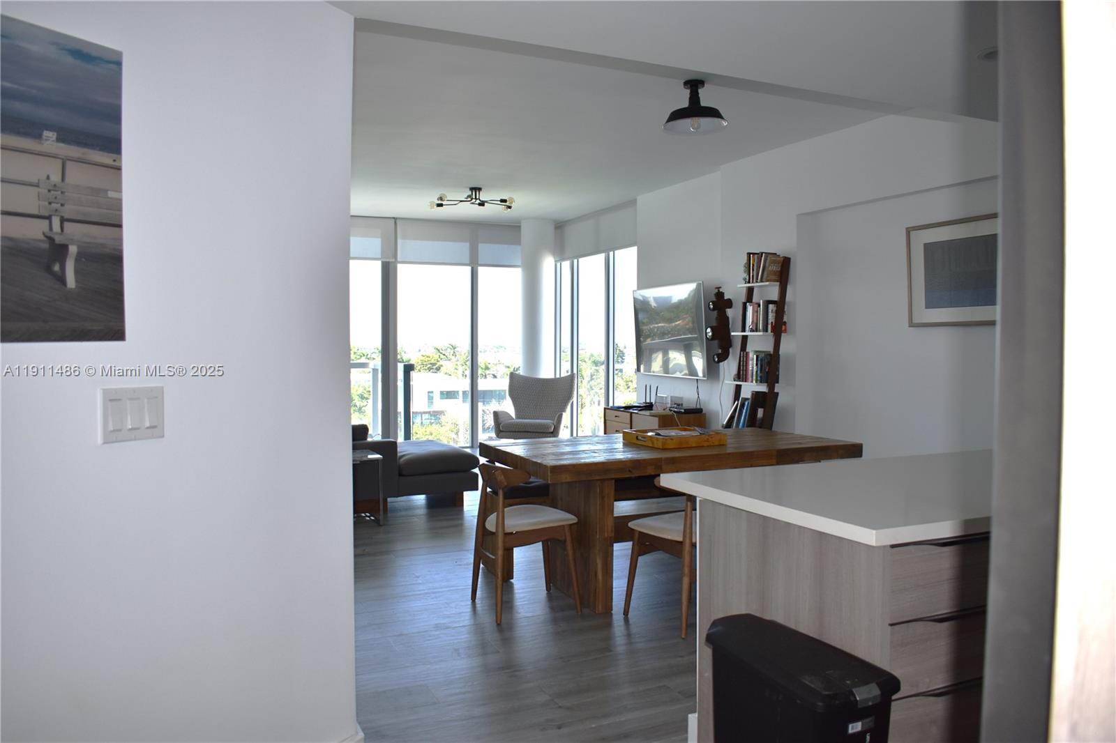 9940 West Bay Harbor Drive, Unit 6DN Bay Harbor Islands, FL 33154 - Photo 7 of 46 a view of a dining room with furniture window and wooden floor