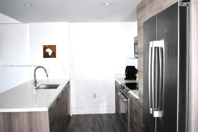 a kitchen with a sink and a refrigerator