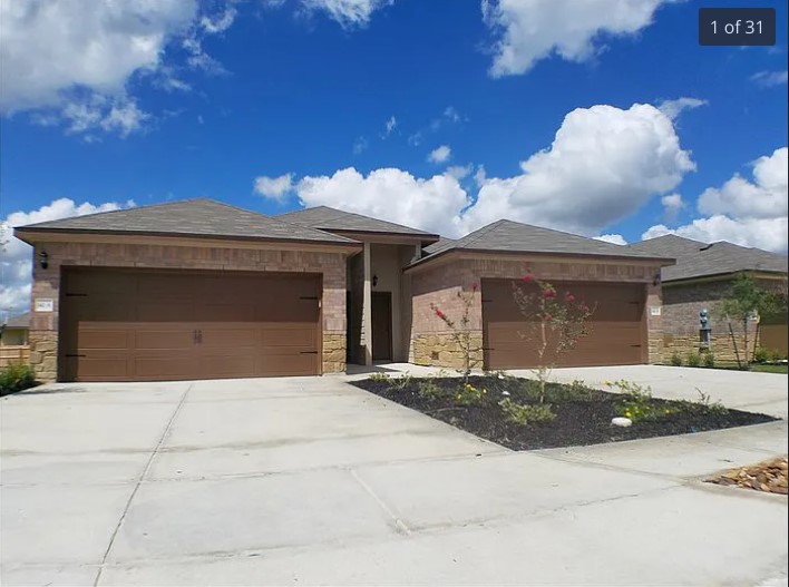 142 Samuel Drive, Unit B Buda, TX 78610 - Photo 1 of 1 a front view of a house with a yard