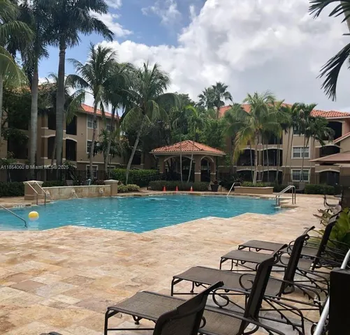 a view of a house with swimming pool and sitting area