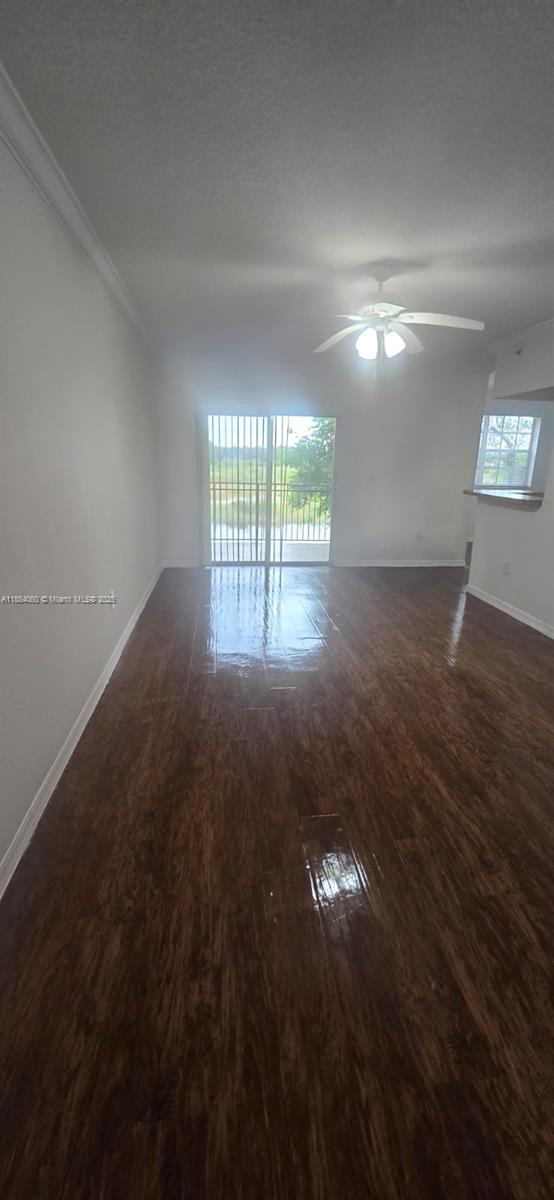 11630 Southwest 2nd Street, Unit 17208 Pembroke Pines, FL 33025 - Photo 12 of 32 wooden floor in an empty room with a window