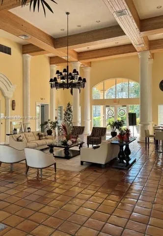 a living room with couches and large dining table with wooden floor
