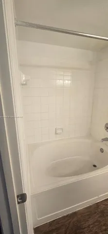 a bathroom with a shower and a bath tub