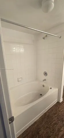 a view of room with wooden floor