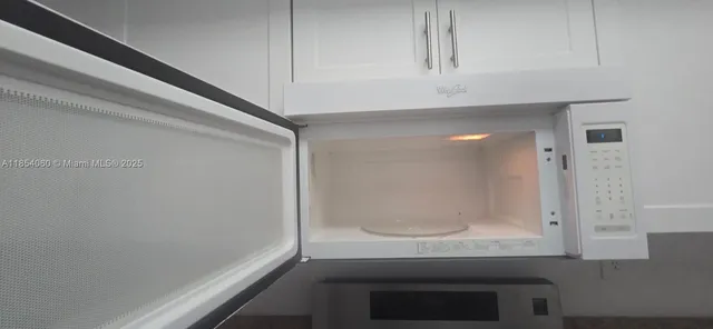 a kitchen with granite countertop a stove and cabinets