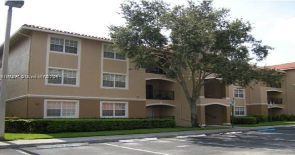 11630 Southwest 2nd Street, Unit 17208 Pembroke Pines, FL 33025 - Photo 3 of 32 a front view of a house with a yard and garage