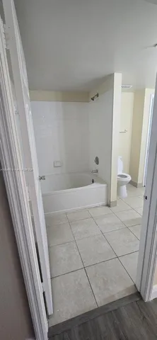 a bathroom with a sink and a glass door shower