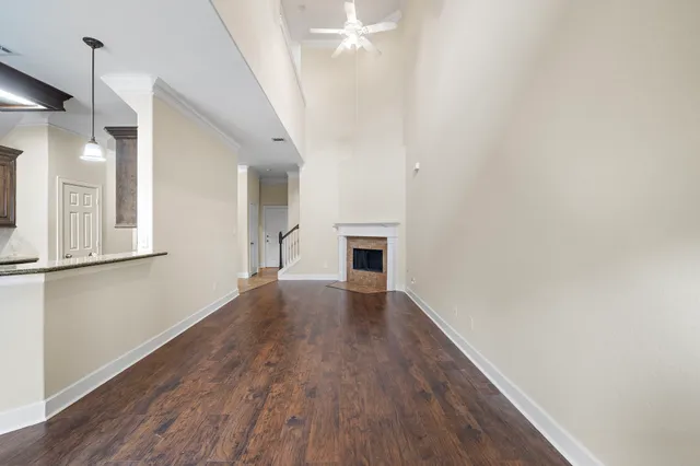 a view of empty room with wooden floor and fireplace
