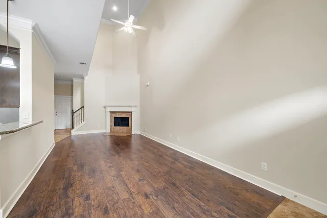 an empty room with wooden floor and fireplace