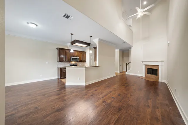 a view of a kitchen with microwave and wooden floor
