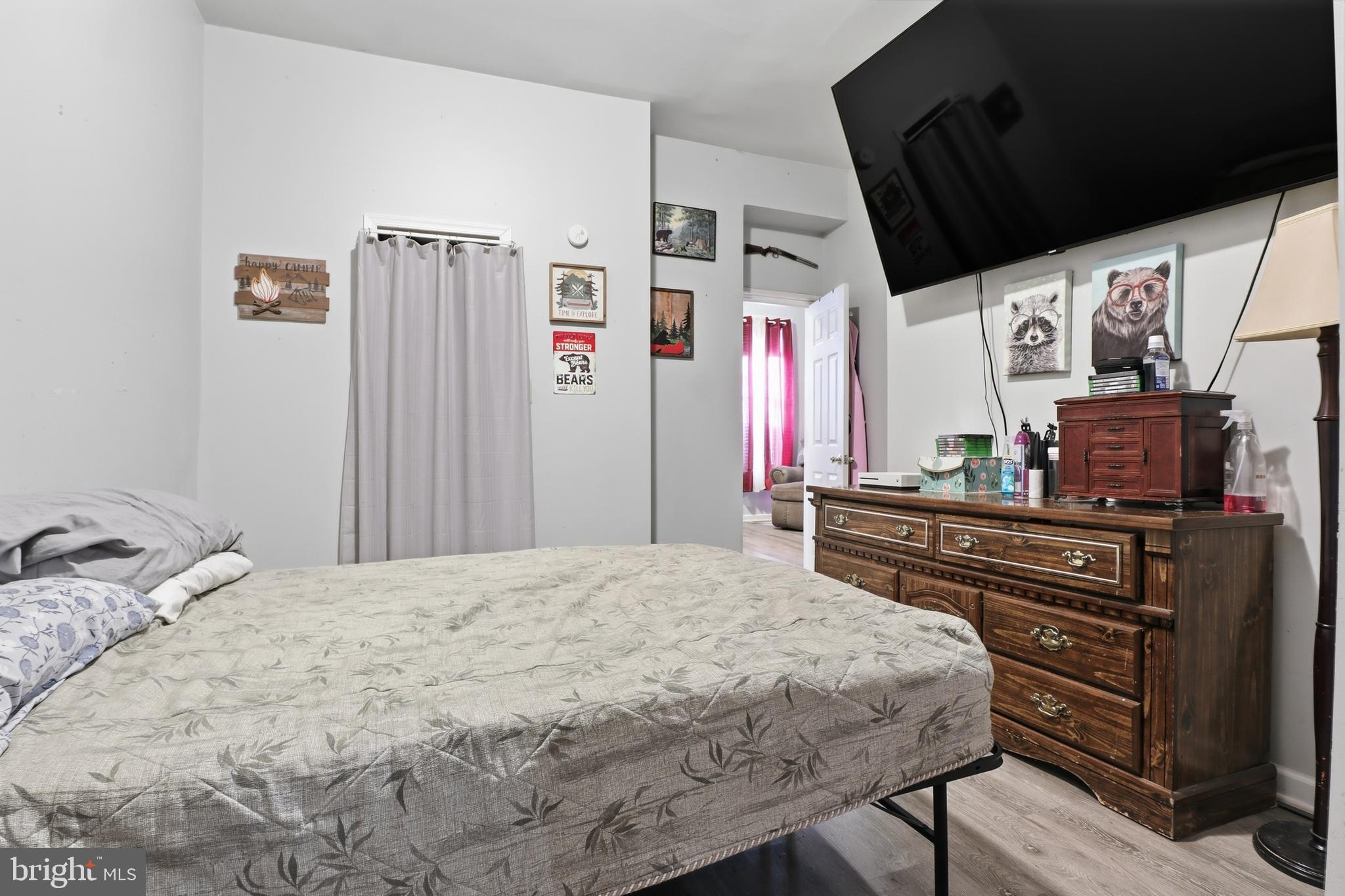 70 North Main Street Dover, PA 17315 - Photo 14 of 43 a bedroom with a bed dresser and a flat tv screen