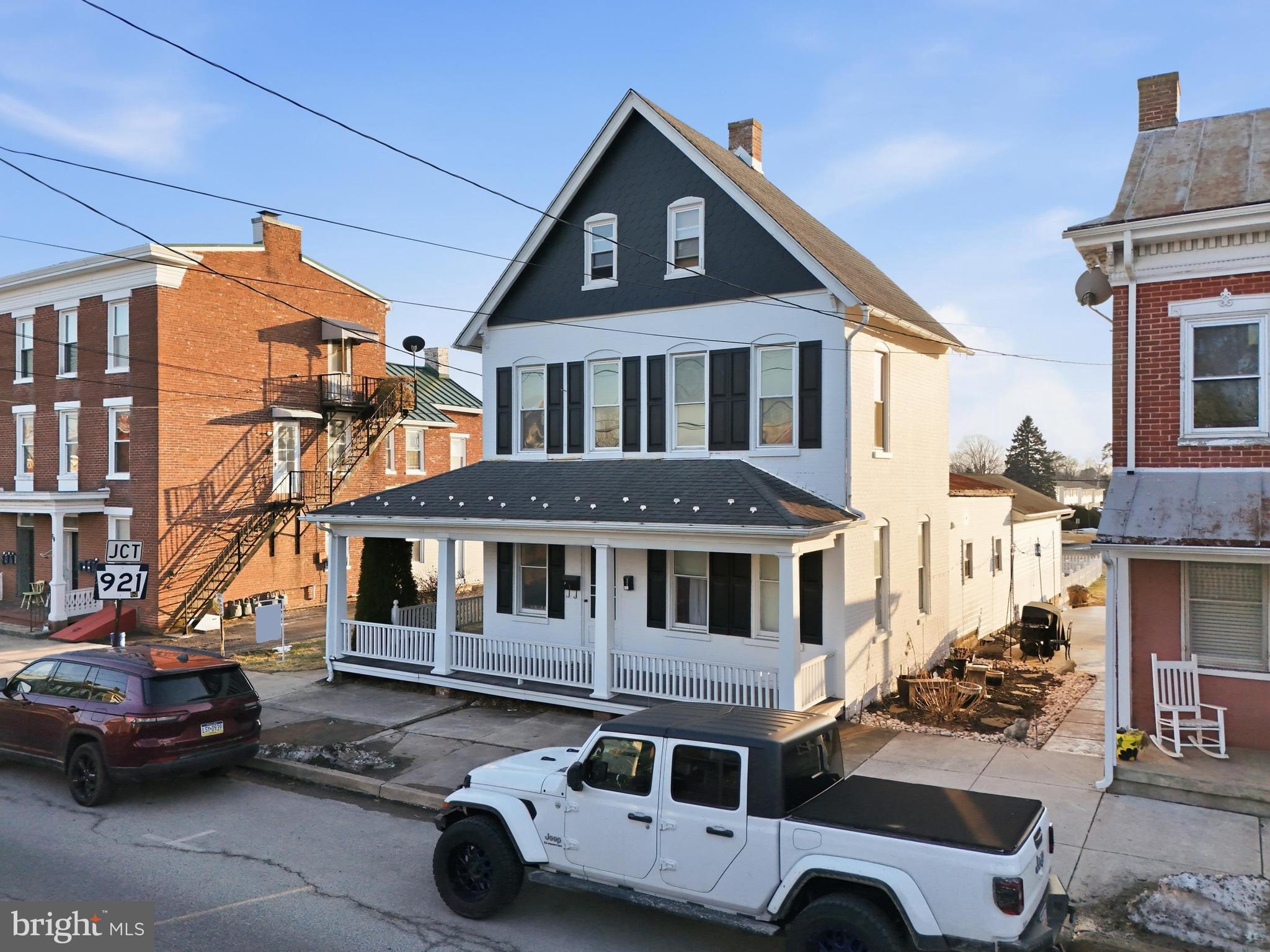 70 North Main Street Dover, PA 17315 - Photo 3 of 43 a car parked in front of a white house