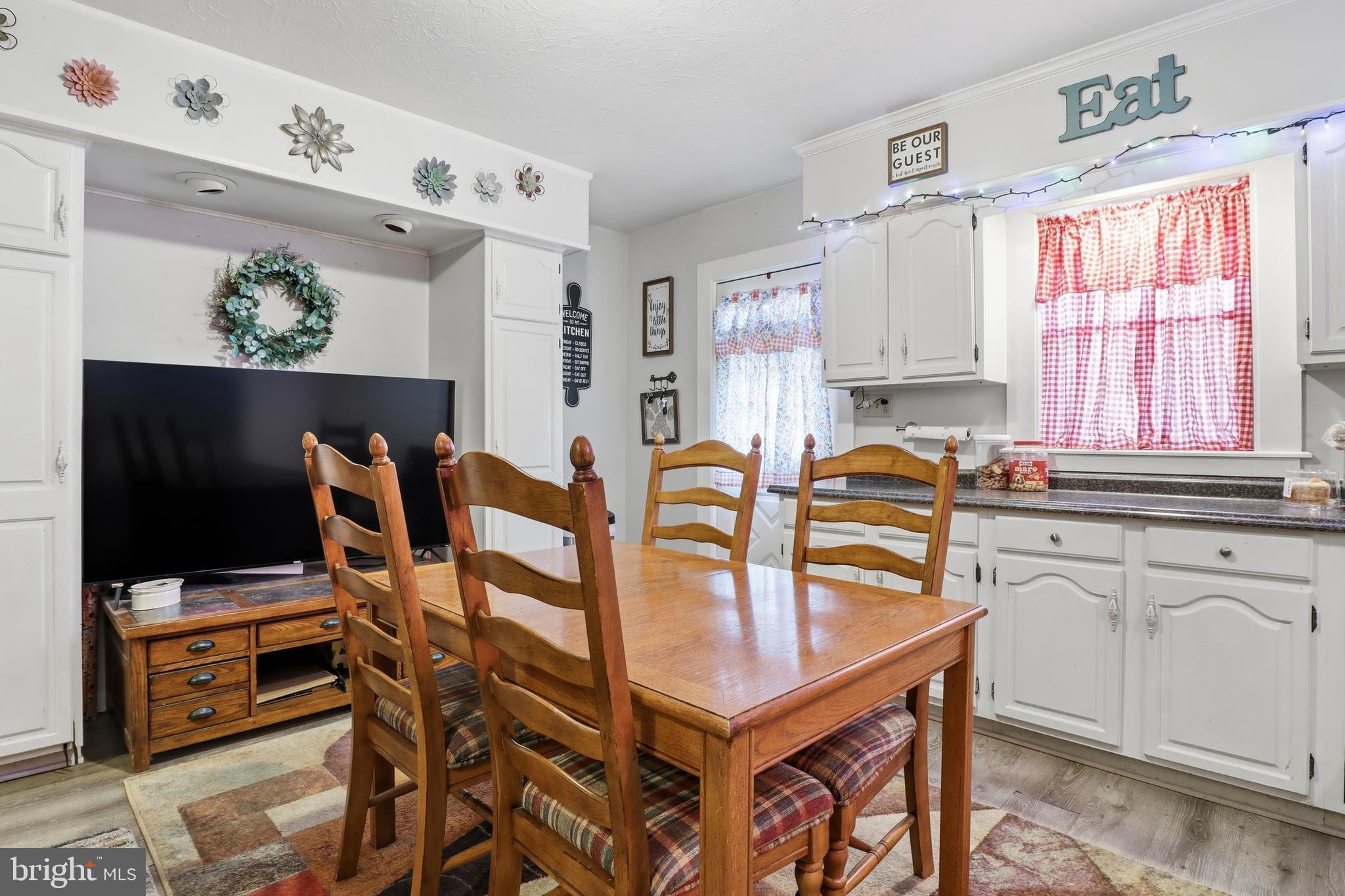 70 North Main Street Dover, PA 17315 - Photo 8 of 43 a kitchen with stainless steel appliances a sink a table and a refrigerator