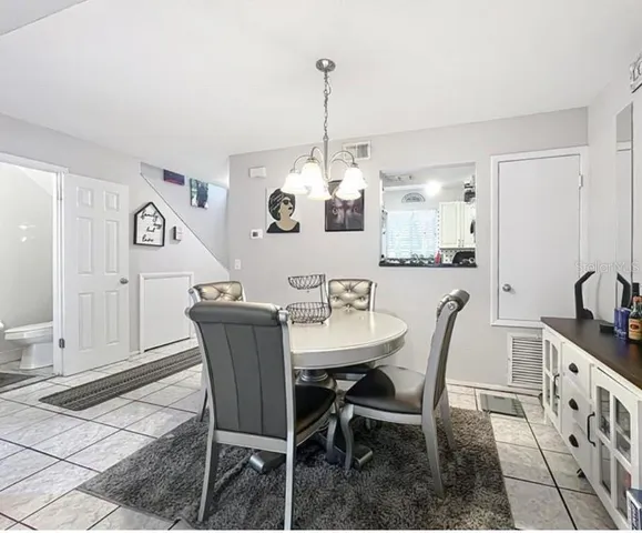 a dining room with furniture and window