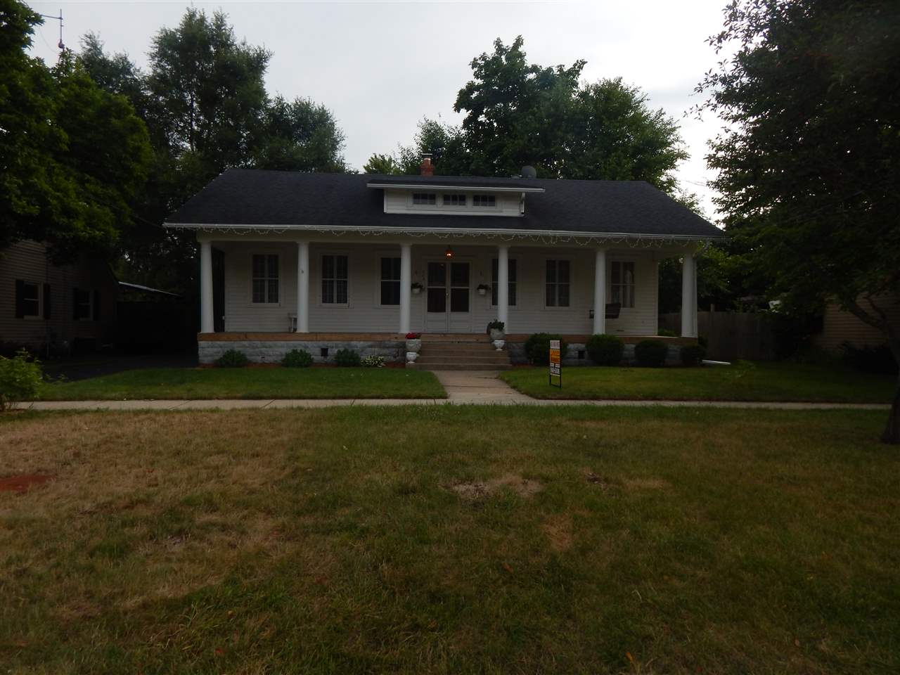 213 Genoa Street Cherry Valley, IL 61016 - Photo 1 of 6 a front view of a house with a garden