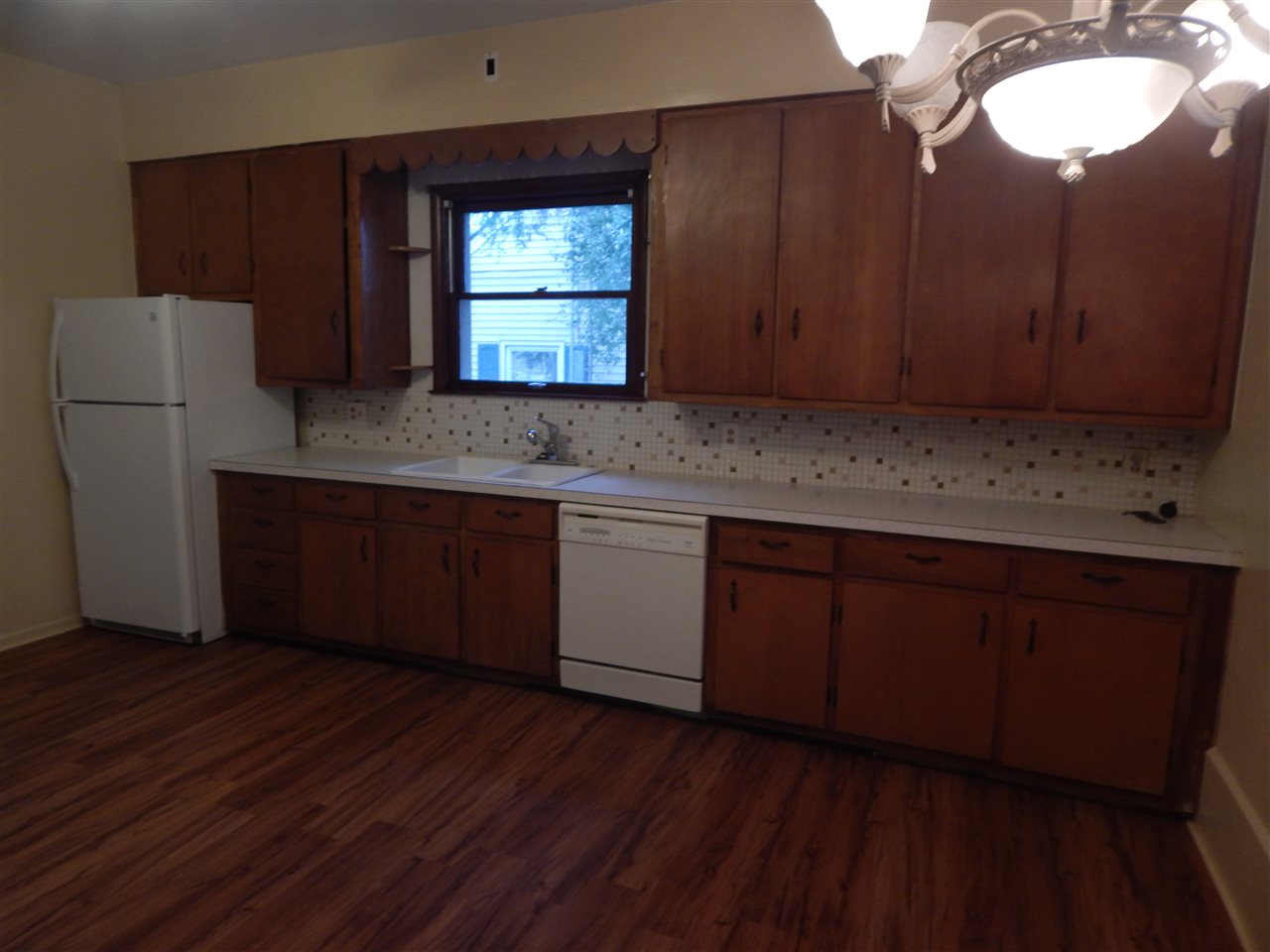 213 Genoa Street Cherry Valley, IL 61016 - Photo 2 of 6 a kitchen with wooden floors and wooden cabinets