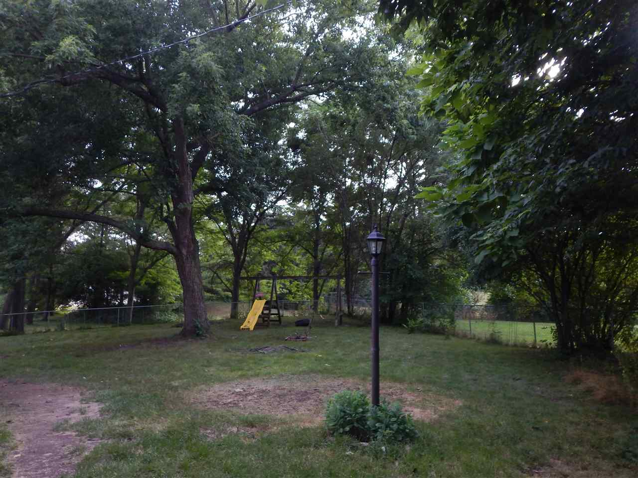 213 Genoa Street Cherry Valley, IL 61016 - Photo 5 of 6 a view of a park with large trees