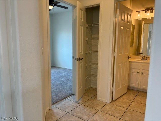 2866 Shimmering Bay Street Laughlin, NV 89029 - Photo 23 of 32 Functional hallway features a convenient linen closet and tiled flooring leading to a bedroom and bathroom.
