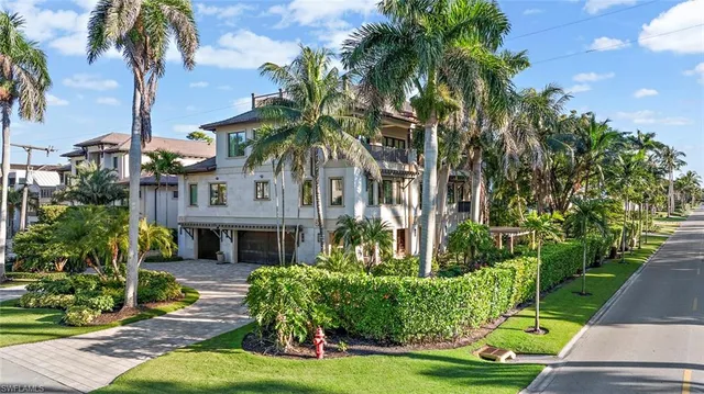 a front view of a house with yard and green space