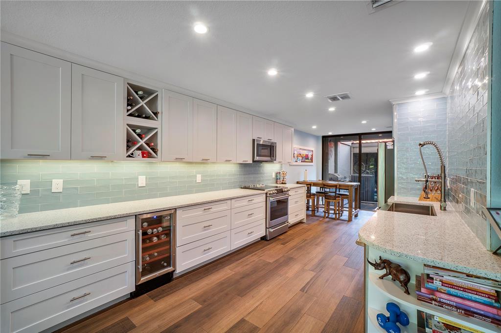 3908 South Ocean Boulevard, Unit TH4 Boca Raton, FL 33487 - Photo 11 of 37 a large kitchen with stainless steel appliances granite countertop a lot of counter space and wooden floors
