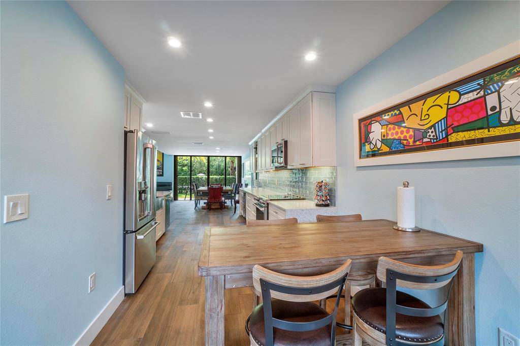3908 South Ocean Boulevard, Unit TH4 Boca Raton, FL 33487 - Photo 13 of 37 a dining room with furniture and wooden floor