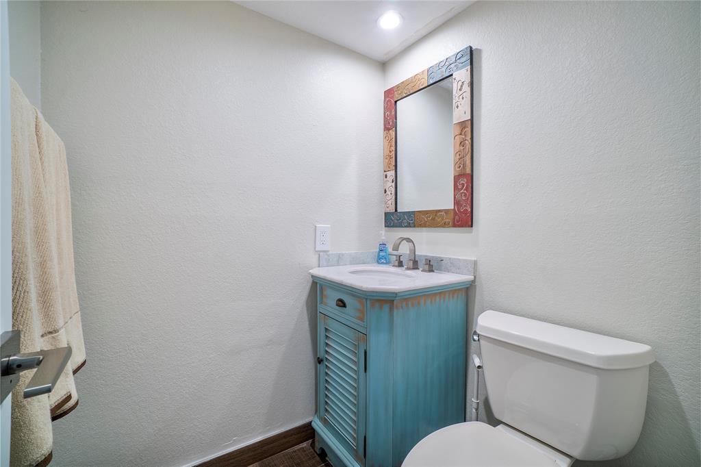 3908 South Ocean Boulevard, Unit TH4 Boca Raton, FL 33487 - Photo 14 of 37 a bathroom with a toilet sink and mirror