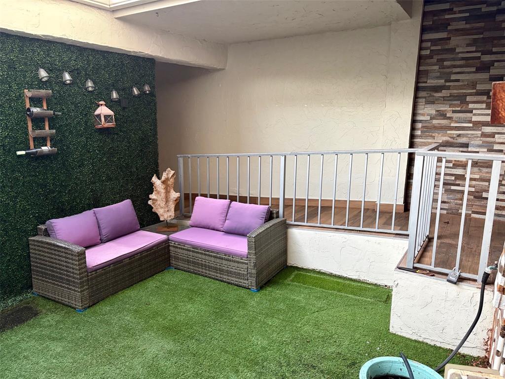 3908 South Ocean Boulevard, Unit TH4 Boca Raton, FL 33487 - Photo 27 of 37 a sitting area with furniture and wooden floor