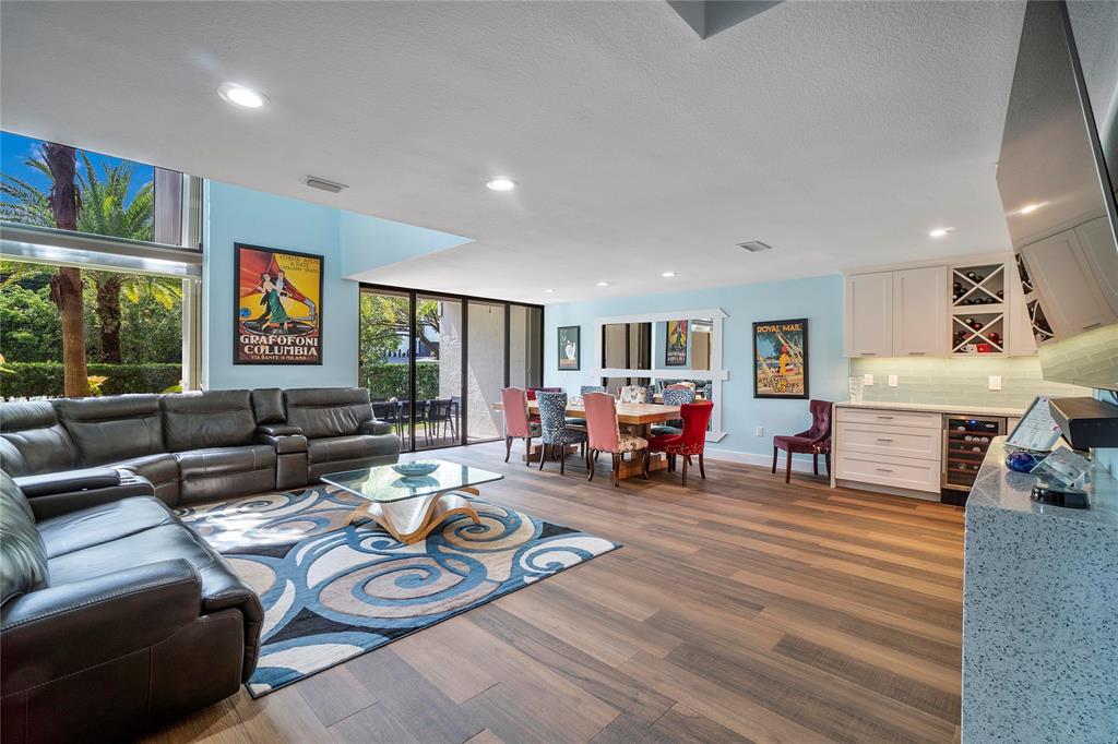 3908 South Ocean Boulevard, Unit TH4 Boca Raton, FL 33487 - Photo 5 of 37 a living room with furniture and a flat screen tv