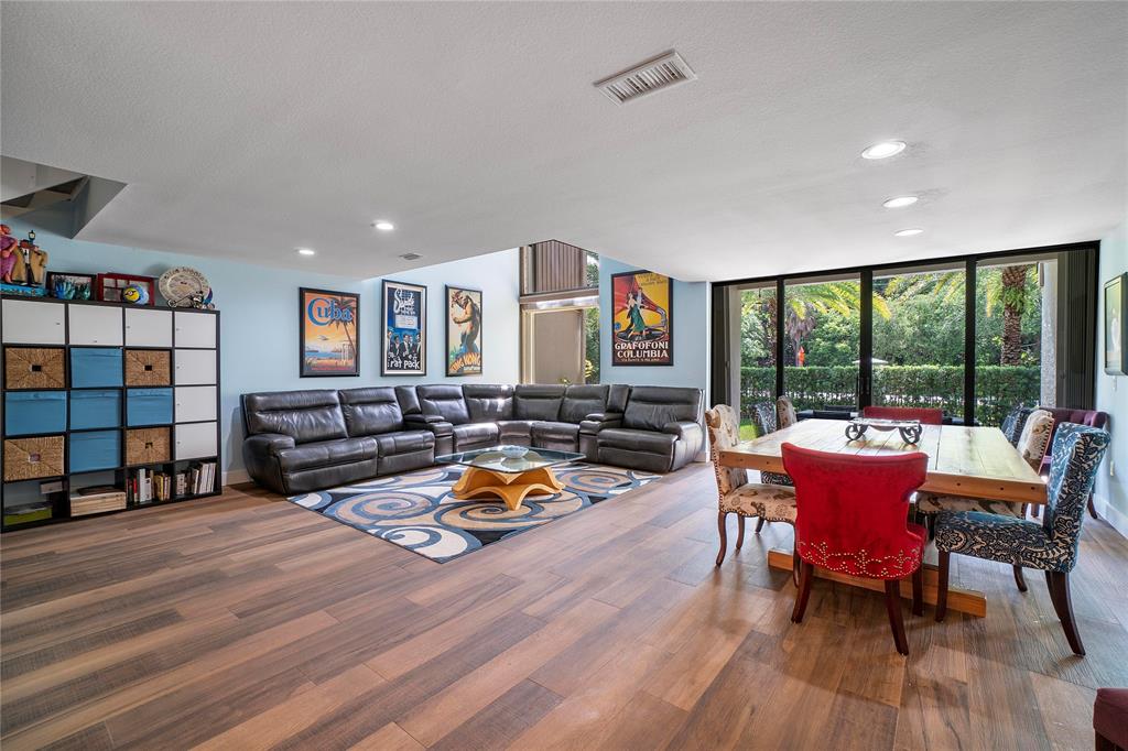 3908 South Ocean Boulevard, Unit TH4 Boca Raton, FL 33487 - Photo 7 of 37 a living room with furniture and a wooden floor