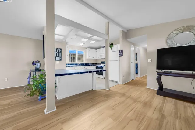 a kitchen with stainless steel appliances granite countertop a refrigerator a sink and a stove