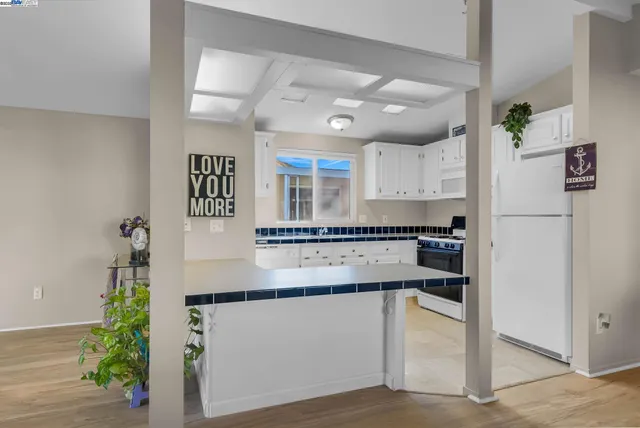a kitchen with granite countertop a sink and cabinets